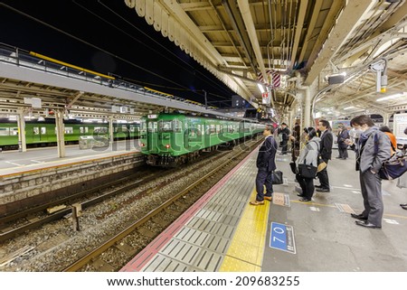 KYOTO - APR 8: Passengers at the platform in Kyoto Station on Apr 8, 2014 in Kyoto. It is a major railway station and transportation hub in Kyoto, has Japan\'s second-largest station building.
