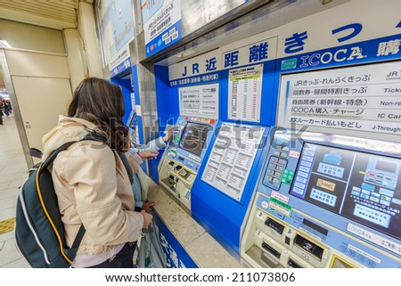 OSAKA - APR 8: Tourists buy ticket from Ticket vending machine in Kyoto Station on Apr 8, 14 in Kyoto. It is a major railway station and transportation hub in Kyoto.