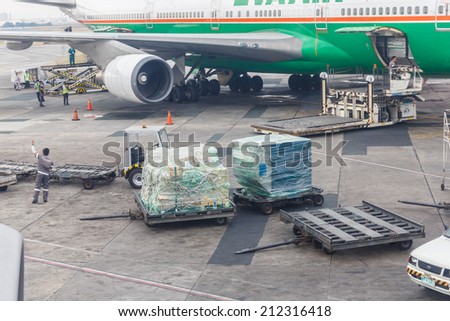 MANILA - FEBRUARY 15: Airport workers at Ninoi International Airport on Feb 15, 14 in Manila, Philippines. It is the airport serving Manila and its surrounding metropolitan area.