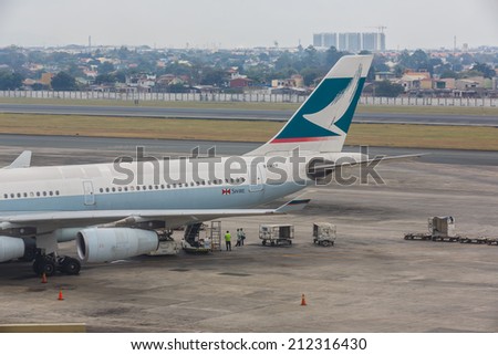 MANILA - FEBRUARY 15: Cathay Pacific flight at Ninoi International Airport on Feb 15, 14 in Manila, Philippines. It is the airport serving Manila and its surrounding metropolitan area.
