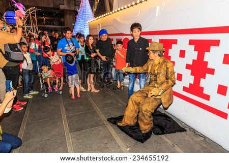 BANGKOK-DEC 30: People enjoy street show at Central World Shopping Center on Dec 30, 2013. It is a shopping plaza and complex in Bangkok which is the sixth largest shopping complex in the world.