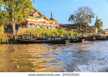 INLE LAKE, MYANMAR - DEC 7: Inle's people and boat on Dec 7, 2014 in Inle, Myanmar. Travel by boat is the major transportation mean both local and tourists in Inle lake.