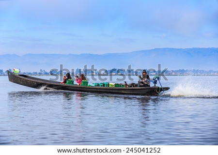 INLE LAKE, MYANMAR - DEC 8: Tourists travel on boat on Dec 8, 2014 in Inle, Myanmar. Travel by boat is the major transportation mean both local and tourists in Inle lake.