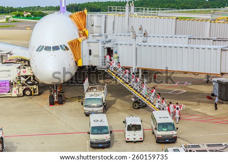 TOKYO - JUL 6: Workers work on Thai Airways flight at Narita Airport on Jul 6, 2014 in Tokyo. The airport is the primary international airport serving the Greater Tokyo Area of Japan.