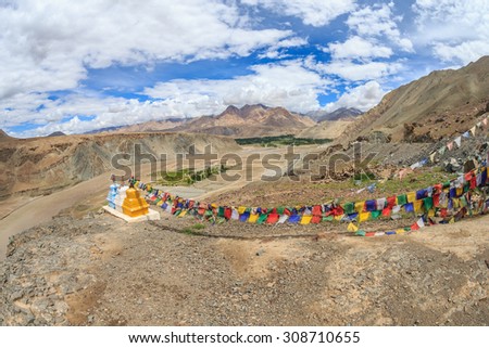 Praying flags and three stupas at Confluence of the Indus and Zanskar Rivers, leh, ladakh, india