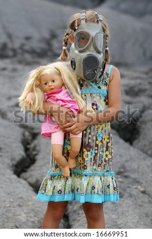 A little girl wearing a gas mask and holding on to her doll.