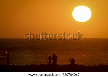 Sunset over the Ocean with people in foreground
