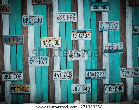 PRACHUAP KHIRI KHAN, THAILAND - FEB 23, 2015: Old US car registration plate on wooden wall in Hua Hin, Prachuap Khiri Khan, Thailand. retro style