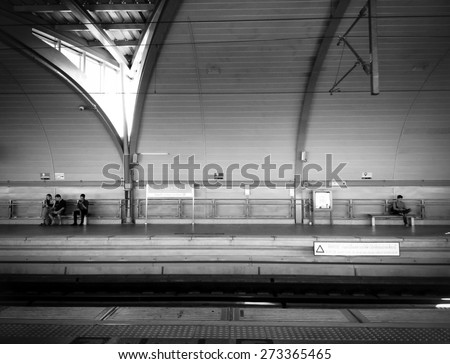 BANGKOK - JAN 15: Asian people waiting for Airport-link train in Ratchaprarod station in black and white on January 15, 2015 in Bangkok, Thailand