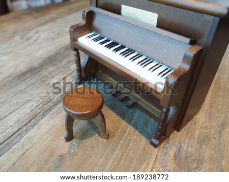 wooden toy piano on vintage table background