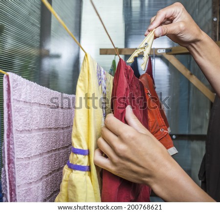 man hang lingerie on the clothesline using clothespins