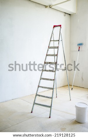 repair of a new apartment, painting the walls with stepladder
