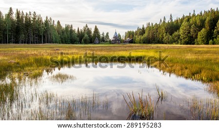 Panorama of the Karelian landscape in Russia, with the forest and the house on the lake.