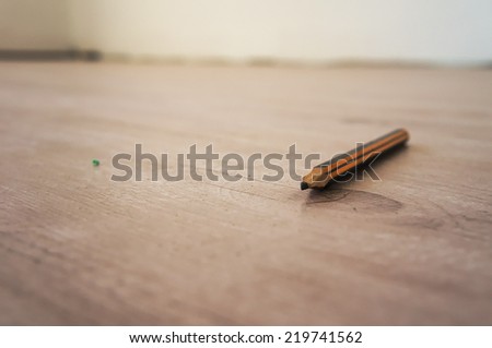 Graphite pen on laminate floor