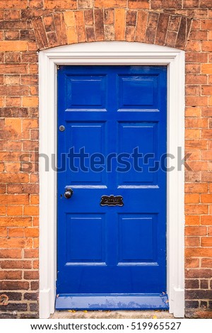Blue door with brick wall at England, UK.