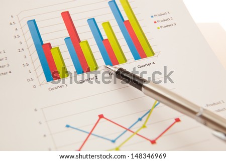 financial charts and graphs with pen