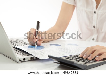 woman hand on laptop with business report