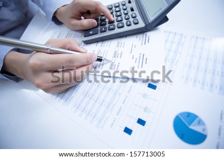 Woman Hand With Pen And Business Report