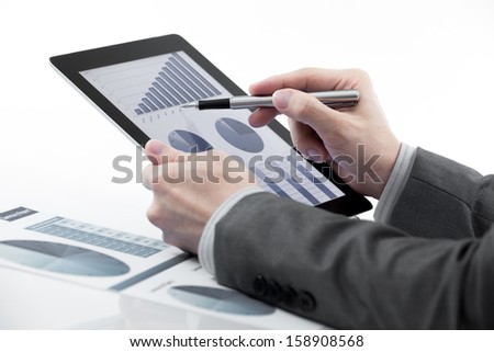 Businessman holding digital tablet with business report