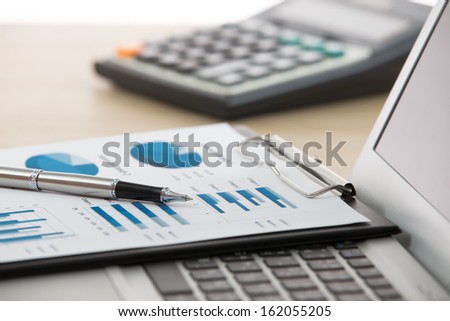 Businessman Analyzing Investment Charts With Laptop