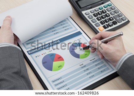 man hand with pen and business report