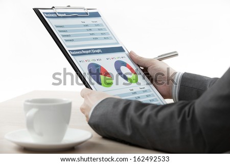 businessman on meeting discussing graphics with coffee