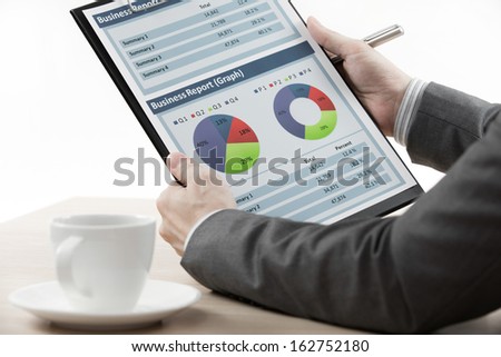 businessman on meeting discussing graphics with coffee