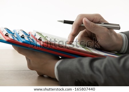 business report and man hand with pen