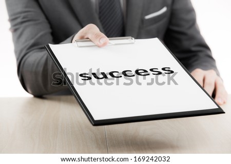 Businessman showing text success on table