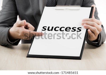 Businessman showing text success on table