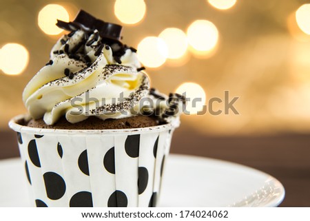 Tasty cupcake with butter cream on lights background