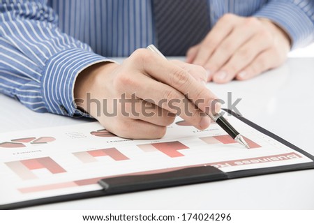 business report and man hand with pen