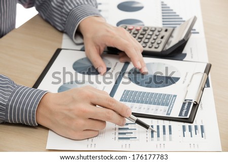 business report and man hand with pen. Accounting