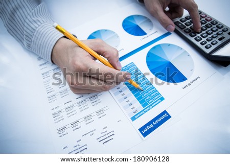 man hand with pen and business report. Accounting