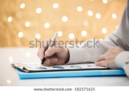 Business report and man hand with pen. Accounting