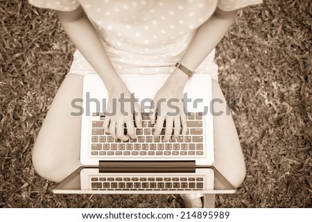 Young Caucasian woman using Laptop on nature