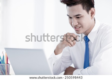 young asian businessman working in office