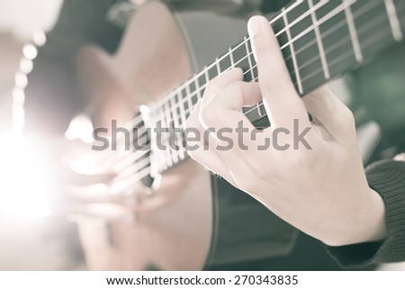 Practicing in playing guitar. Handsome young men playing guitar