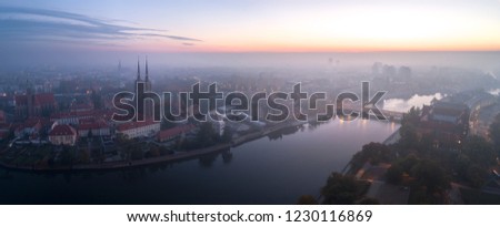 Aerial view of the smog over the waking city at dawn, in the distance buildings covered with fog and smog - Wroclaw, Poland