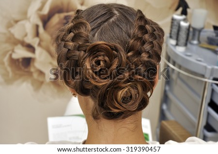 Beautiful wedding hairstyle. The bride\'s hairstyle in the beauty salon. Rear view.