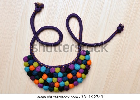Colorful balls of wool. Colorful felt balls. Dried balls of wool. Colored beads. Felt handmade. Necklace with colorful beads