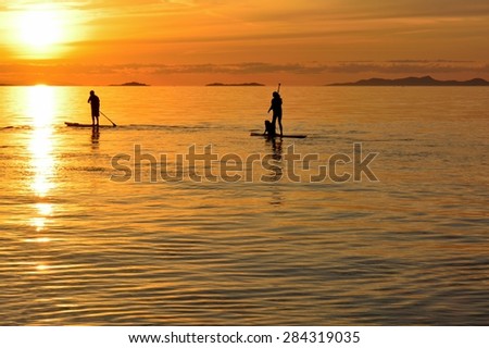 Heading For The Sun\
Paddle boarders are chasing a beautiful sunset on the Strait of Georgia.