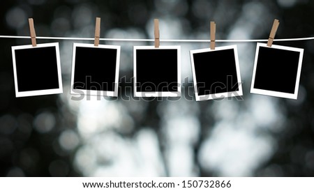 Blank Photographs Hanging On A Clothesline Against A Bokeh Lights Background