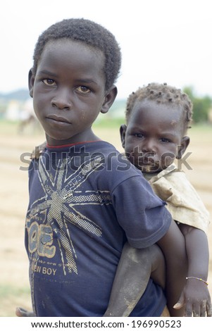 MUKJAR ,Southern Sudan - September 16, 2011 : Unidentified young African boys pose and look at camera.People of Benin suffer of poverty due to the difficult economic situation.