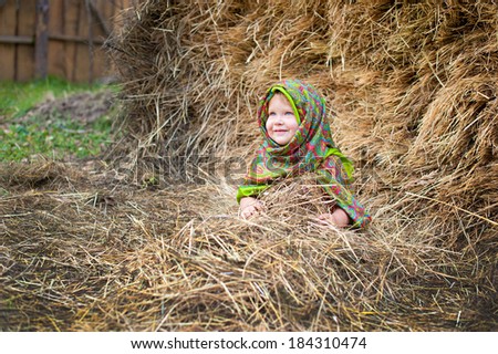Close up image of beautiful little girl in russian village traditional kerchief with round cracknel with russian ornamen over autumn weather/Lovely russian young gir