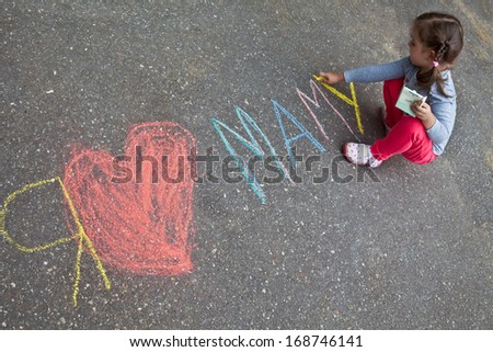 Girl with pigtails wrote in chalk on the pavement, \