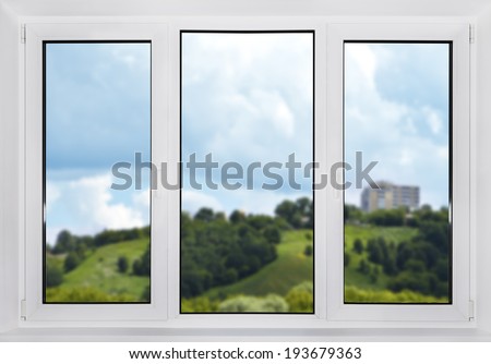 Modern plastic window with views of the countryside. In the focus window.