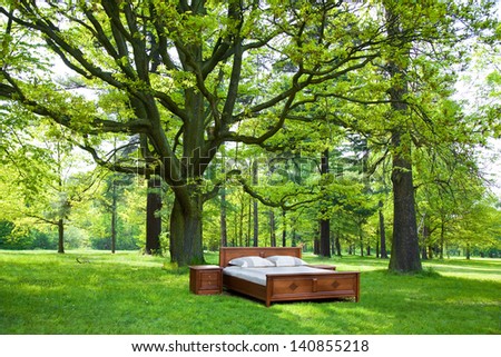 bed in a forest- concept of good sleep