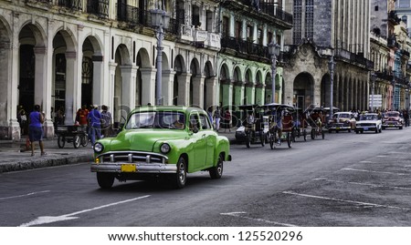 Havana, Cuba. Street Scene With Old Car And Worn Out Buildings.