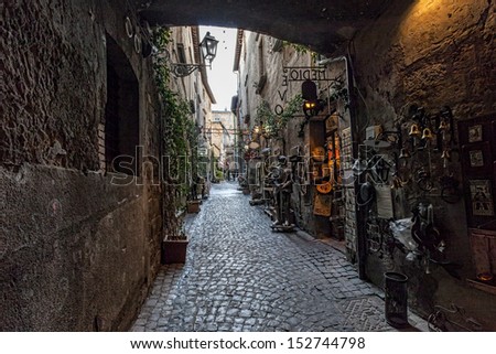 Orvieto in Umbria, Italy, narrow street with small shops.